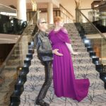 Bryce Dallas Howard Instagram – Joyful Moments with @jeffgoldblum: the B-side #JurassicWorldDominion ⁣
⁣
[ID: Candid photos of Jeff and BDH playfully posing on the steps of a grand staircase. Jeff wears an all black leather ensemble and BDH wears a plum floor-length gown.]