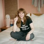 Bryce Dallas Howard Instagram – Mercury is Retrograde! In Virgo! To use the words of astrologer and writer @chaninicholas, “Good luck to us all!”⁣⁣
⁣
📸: Andie Jane (@andiejjane)⁣⁣
⁣⁣
[ID: BDH sits cross-legged on top of a fluffy white comforter. She points to her black t-shirt which reads, “but mercury is in retrograde.”]