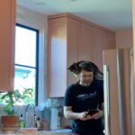 Bryce Dallas Howard Instagram - My hot husband is juggling it all (kids, pets, moving, new schools) all while I’ve been filming in the UK. This is our cat Bruno balancing on his back — it’s a new thing. He perches on Seth’s shoulders. ⁣⁣ ⁣⁣ We are all very needy with Seth because he’s everyone’s favorite person. He’s turning 40 today and it feels like lifetimes ago and also just yesterday that he turned 20 and we were two crazy kids in love. I love our life together and I love you, Seth. Happy Birthday ♥️⁣ ⁣ [Images: a picture of Seth wearing a blue t-shirt and red shorts, standing in a pink kitchen and looking at his phone; a selfie of Seth sitting against a grey tile wall; both images with our brown cat Bruno perched on his shoulders like a parrot.]
