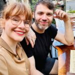 Bryce Dallas Howard Instagram – When “date night” is in broad daylight cause you have kids 😂⁣
⁣
[ID: A profile selfie of BDH (left) and Seth (right) sitting at a wooden communal-style table for dinner.]