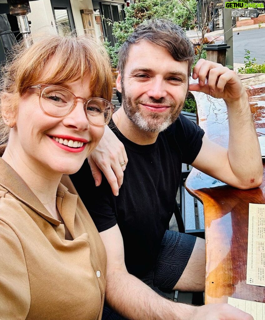 Bryce Dallas Howard Instagram - When “date night” is in broad daylight cause you have kids 😂⁣ ⁣ [ID: A profile selfie of BDH (left) and Seth (right) sitting at a wooden communal-style table for dinner.]