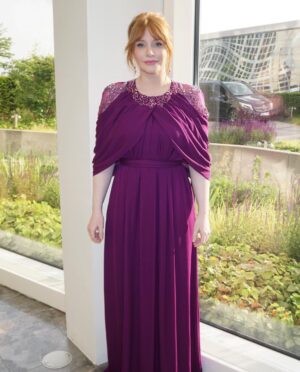 Bryce Dallas Howard Instagram - Dinosaurs, but make it fashion 🦖 Thank you Germany for being an incredible last stop on this leg of our international travels!! Next stop, home sweet home: Los Angeles! #JurassicWorldDominion ⁣
⁣
Makeup: Kara Bua (@karayoshimotobua) ⁣⁣⁣⁣⁣
London/ Germany Hair: Christian Wood (@cwoodhair)⁣⁣⁣
Manicure: Ariane Brimah⁣
And special thanks to @alex.schack✨⁣
⁣
[ID 1 & 2: BDH signs autographs, wearing a plum floor-length Pamella Roland gown with fancy silver beading along the neckline and sleeves.]⁣
⁣
[ID 3: In front of a dinosaur installation in Trafalgar Square, BDH wears a bright tennis-ball yellow Alex Perry dress with an angular silhouette and neck cutout]⁣
⁣
[ID 4 & 5: Rexy and BDH roar in Germany; BDH wears a midi red Valentino dress with matching red pumps that made her very tall]⁣
⁣
[ID 6: Izzy Sermon, BDH, and Laura Dern speak at the London crew screening of Jurassic World Dominion. BDH wears a caramel-hued Self Portrait mesh midi dress and black blazer. She’s emotional saying thank you to all the people]