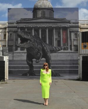Bryce Dallas Howard Instagram - Dinosaurs, but make it fashion 🦖 Thank you Germany for being an incredible last stop on this leg of our international travels!! Next stop, home sweet home: Los Angeles! #JurassicWorldDominion ⁣
⁣
Makeup: Kara Bua (@karayoshimotobua) ⁣⁣⁣⁣⁣
London/ Germany Hair: Christian Wood (@cwoodhair)⁣⁣⁣
Manicure: Ariane Brimah⁣
And special thanks to @alex.schack✨⁣
⁣
[ID 1 & 2: BDH signs autographs, wearing a plum floor-length Pamella Roland gown with fancy silver beading along the neckline and sleeves.]⁣
⁣
[ID 3: In front of a dinosaur installation in Trafalgar Square, BDH wears a bright tennis-ball yellow Alex Perry dress with an angular silhouette and neck cutout]⁣
⁣
[ID 4 & 5: Rexy and BDH roar in Germany; BDH wears a midi red Valentino dress with matching red pumps that made her very tall]⁣
⁣
[ID 6: Izzy Sermon, BDH, and Laura Dern speak at the London crew screening of Jurassic World Dominion. BDH wears a caramel-hued Self Portrait mesh midi dress and black blazer. She’s emotional saying thank you to all the people]