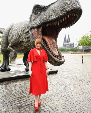 Bryce Dallas Howard Instagram - Dinosaurs, but make it fashion 🦖 Thank you Germany for being an incredible last stop on this leg of our international travels!! Next stop, home sweet home: Los Angeles! #JurassicWorldDominion ⁣
⁣
Makeup: Kara Bua (@karayoshimotobua) ⁣⁣⁣⁣⁣
London/ Germany Hair: Christian Wood (@cwoodhair)⁣⁣⁣
Manicure: Ariane Brimah⁣
And special thanks to @alex.schack✨⁣
⁣
[ID 1 & 2: BDH signs autographs, wearing a plum floor-length Pamella Roland gown with fancy silver beading along the neckline and sleeves.]⁣
⁣
[ID 3: In front of a dinosaur installation in Trafalgar Square, BDH wears a bright tennis-ball yellow Alex Perry dress with an angular silhouette and neck cutout]⁣
⁣
[ID 4 & 5: Rexy and BDH roar in Germany; BDH wears a midi red Valentino dress with matching red pumps that made her very tall]⁣
⁣
[ID 6: Izzy Sermon, BDH, and Laura Dern speak at the London crew screening of Jurassic World Dominion. BDH wears a caramel-hued Self Portrait mesh midi dress and black blazer. She’s emotional saying thank you to all the people]