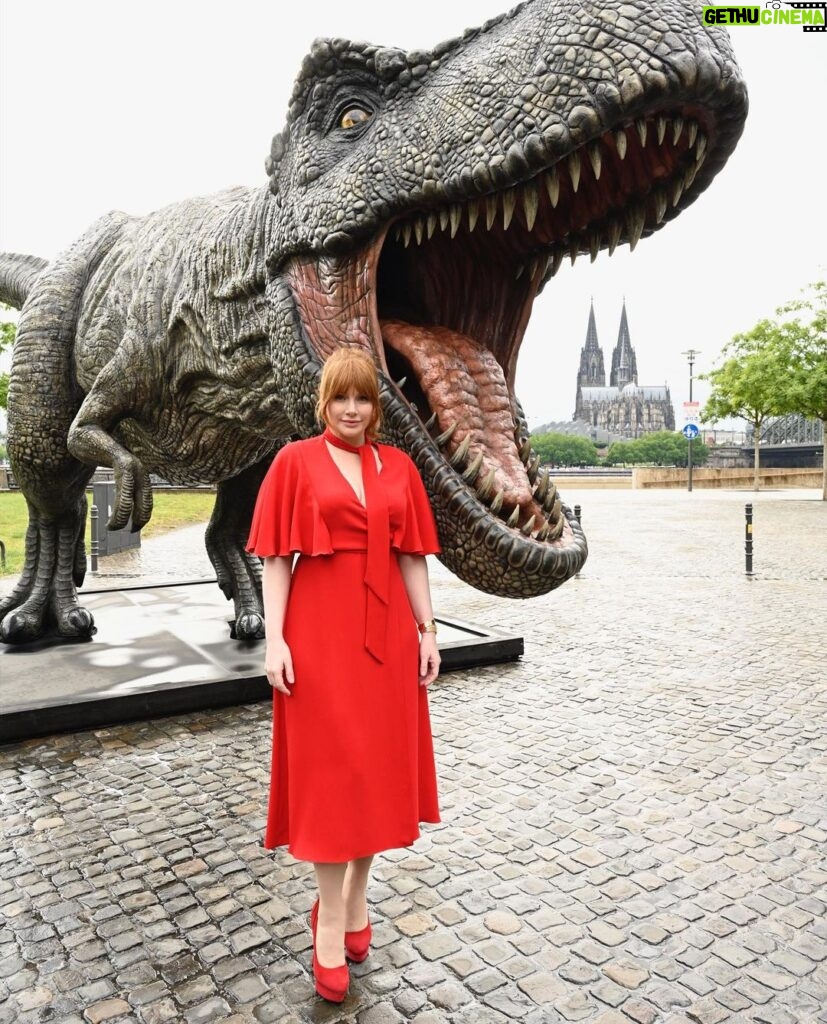 Bryce Dallas Howard Instagram - Dinosaurs, but make it fashion 🦖 Thank you Germany for being an incredible last stop on this leg of our international travels!! Next stop, home sweet home: Los Angeles! #JurassicWorldDominion ⁣ ⁣ Makeup: Kara Bua (@karayoshimotobua) ⁣⁣⁣⁣⁣ London/ Germany Hair: Christian Wood (@cwoodhair)⁣⁣⁣ Manicure: Ariane Brimah⁣ And special thanks to @alex.schack✨⁣ ⁣ [ID 1 & 2: BDH signs autographs, wearing a plum floor-length Pamella Roland gown with fancy silver beading along the neckline and sleeves.]⁣ ⁣ [ID 3: In front of a dinosaur installation in Trafalgar Square, BDH wears a bright tennis-ball yellow Alex Perry dress with an angular silhouette and neck cutout]⁣ ⁣ [ID 4 & 5: Rexy and BDH roar in Germany; BDH wears a midi red Valentino dress with matching red pumps that made her very tall]⁣ ⁣ [ID 6: Izzy Sermon, BDH, and Laura Dern speak at the London crew screening of Jurassic World Dominion. BDH wears a caramel-hued Self Portrait mesh midi dress and black blazer. She’s emotional saying thank you to all the people]