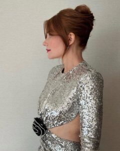 Bryce Dallas Howard Instagram - A magical night at the BAFTAs in London 🎭🪩⁣ ⁣ Hair: @cwoodhair ⁣ Makeup: @kaymontano⁣ Styled by Publicist Extraordinaire: @alex.schack 📸 1+6: @cwoodhair⁣ 📸 2-5: @gettyentertainment @BAFTA ⁣ #EEBAFTAs⁣ ⁣ [ID: Arriving on the red carpet with her hair in a relaxed up-do, BDH wears a silver sequined long-sleeve dress from @newarrivals.co with a cut-out around the waist ending with a black rose. Paired with the dress are a pair of black @maisonvalentino platform heels and a silver beaded bracelet & ring from @bulgari.]