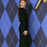 Bryce Dallas Howard Instagram - London, you make my heart so full! ❤️ #ArgylleMoviePremiere⁣ ⁣⁣ 📸: Getty Images for Universal Pictures Hair: @cwoodhair⁣⁣ Makeup: @karayoshimotobua⁣⁣ Styled by Publicist Extraordinaire: @alex.schack⁣⁣ ⁣⁣ [ID: In front of blue and yellow Argylle-themed backdrops, BDH poses for photos at the UK premiere of #ArgylleMovie. She wears a long, glittering emerald green dress with a deep v-neckline and deep crimson lipstick. Her straightened hair falls behind her back to show off her earrings.] Odeon Luxe Leicester Square