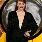 Bryce Dallas Howard Instagram - London, you make my heart so full! ❤️ #ArgylleMoviePremiere⁣ ⁣⁣ 📸: Getty Images for Universal Pictures Hair: @cwoodhair⁣⁣ Makeup: @karayoshimotobua⁣⁣ Styled by Publicist Extraordinaire: @alex.schack⁣⁣ ⁣⁣ [ID: In front of blue and yellow Argylle-themed backdrops, BDH poses for photos at the UK premiere of #ArgylleMovie. She wears a long, glittering emerald green dress with a deep v-neckline and deep crimson lipstick. Her straightened hair falls behind her back to show off her earrings.] Odeon Luxe Leicester Square