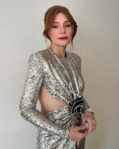 Bryce Dallas Howard Instagram - A magical night at the BAFTAs in London 🎭🪩⁣ ⁣ Hair: @cwoodhair ⁣ Makeup: @kaymontano⁣ Styled by Publicist Extraordinaire: @alex.schack 📸 1+6: @cwoodhair⁣ 📸 2-5: @gettyentertainment @BAFTA ⁣ #EEBAFTAs⁣ ⁣ [ID: Arriving on the red carpet with her hair in a relaxed up-do, BDH wears a silver sequined long-sleeve dress from @newarrivals.co with a cut-out around the waist ending with a black rose. Paired with the dress are a pair of black @maisonvalentino platform heels and a silver beaded bracelet & ring from @bulgari.]