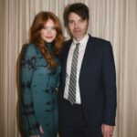 Bryce Dallas Howard Instagram - Many things to toast this weekend 🥂 A @universalpictures family reunion for the ages, 3 weeks until the @argyllemovie premiere, a fresh haircut from @misterjasonlow, and most importantly, my hot date @stealthgabel 💋 📸: @andiejjane [ID: Debuting a middle part after many, many years, BDH wears her hair down and a fitted long-sleeve dress with a moss & black dye print. As she gets ready for the Universal Pictures party, she takes photos around the house and with the ever-handsome Seth Gabel.]