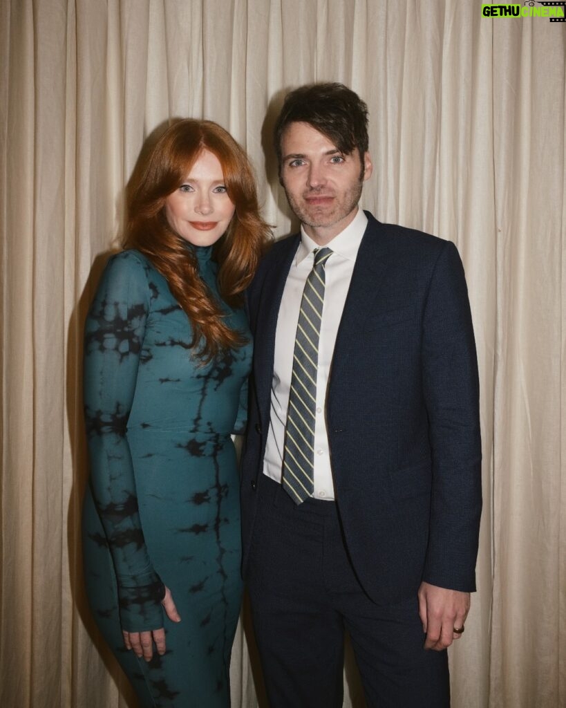 Bryce Dallas Howard Instagram - Many things to toast this weekend 🥂 A @universalpictures family reunion for the ages, 3 weeks until the @argyllemovie premiere, a fresh haircut from @misterjasonlow, and most importantly, my hot date @stealthgabel 💋 📸: @andiejjane [ID: Debuting a middle part after many, many years, BDH wears her hair down and a fitted long-sleeve dress with a moss & black dye print. As she gets ready for the Universal Pictures party, she takes photos around the house and with the ever-handsome Seth Gabel.]