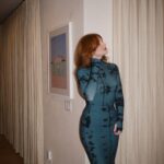 Bryce Dallas Howard Instagram - Many things to toast this weekend 🥂 A @universalpictures family reunion for the ages, 3 weeks until the @argyllemovie premiere, a fresh haircut from @misterjasonlow, and most importantly, my hot date @stealthgabel 💋 📸: @andiejjane [ID: Debuting a middle part after many, many years, BDH wears her hair down and a fitted long-sleeve dress with a moss & black dye print. As she gets ready for the Universal Pictures party, she takes photos around the house and with the ever-handsome Seth Gabel.]