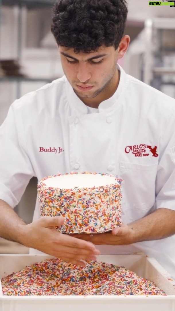 Buddy Valastro Instagram - A baking lesson with the @buddyvalastrojr_ as he perfects our delicious Vanilla Rainbow Cake! 🤩🌈🎂 Add some color to your day with our Rainbow Cakes! Visit carlosbakery.com today! 🚀💫 #carlosbakery #cakeboss #rainbowcake #cake #fatherandson