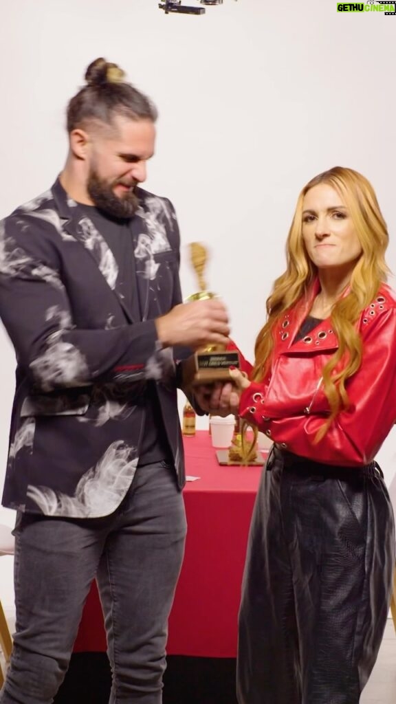 Colby Lopez Instagram - NEW Hot Ones Versus episode with pro wrestling power couple @wwerollins and @beckylynchwwe 🔥 They will either need to tell the truth, or do a battle with some DEATH WINGS. Who will take home the golden chicken wing trophy? 🍗🏆 Find out NOW 👀 Link in bio.