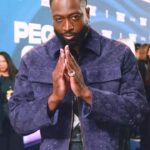 Cole Walliser Instagram - D-WADE came correct at this years People’s Choice Awards! I dug the purple outfit and stoked he came up with the prayer / namaskar pose cause I defintiely didn’t want to suggest him shooting a basketball (lol can you imagine? 😂) He was so rad, and I’m always astonished, grateful and humbled at the idea of him being familar with my content. I know he isn’t playing anymore, but to me he’s the Miami Ambassador, so LET’S GO HEAT!! Or you got The Nuggets!!?? Tell me below who you got! #dwaynewade #colewalliser #miamiheat #PeoplesChoice #livefrome #glambotbts