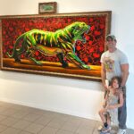 Cooper Barnes Instagram - Robert Xiaver Burden appreciation post! I have been a fan of this guy’s incredible paintings (made from oils and pure nerd nostalgia) for years, and he was kind and generous enough to give my family a tour of his current exhibit a couple days ago. If you happen to be in or near Oceanside CA this week, I highly recommend checking out the last week of his ‘Relics’ exhibit at the @oceansidemuseum before it ends on June 4th. These have to be seen to be believed. #robertxavierburden #oilpainting #battlecat #optimusprime #80snostalgia @transformersofficial @hemania @oceansidemuseum