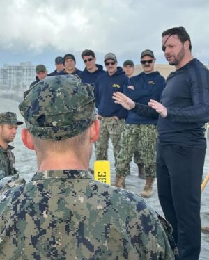 Dan Crenshaw Instagram - Hooyah BUD/S class 364! It was an honor to hit the surf with these 25 men as they savored their last moment of Hell Week. 

Hell Week is the 4th week of the 6 month BUD/S crucible. It is the true gut test that screens out candidates who might quit under pressure. It begins on a Sunday and ends on a Friday morning. This class started with a 115 students, and is now down to 25. Only in very rare cases does anyone quit training after Hell Week. They might be removed for other reasons, but they’ve proven that they’d rather put their body through immense suffering before they quit. After Hell Week, we actually start teaching them skills. It’s a waste of time to teach students SEAL skill sets before they’ve proven themselves in Hell Week.

My BUD/S class was 264. So class 364 is my centennial class, which is why I came out to see them secure Hell Week.

This is the first time I’ve actually seen anyone finish Hell Week outside my own experience back in 2006 (and again in 2007). You can see from the video how much pain these guys have endured. By the end, your body is chafed, frozen to the bone, swollen, and you’re hallucinating on top of that. I wonder if these guys will even remember I was there!

Those are some hard men. They are still well over a year away from becoming SEALs. There’s lots more training and challenges to overcome. But now we know that they have what it takes. Huge congratulations to these guys. 

Follow @navy.seal.swcc for more info