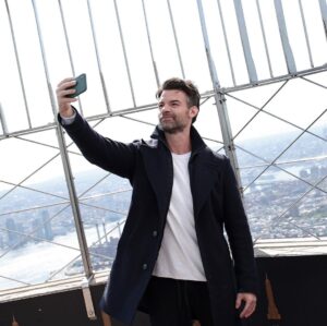 Daniel Gillies Instagram - so fun.

yesterday we did a little shoot in the Empire State Building. @empirestatebldg 

super impressive and a such a joy when you’re promoting the best film of 2021:

‘Coming Home in the Dark’ releases this Friday on VOD and in Theatres, stateside. 

(Yes, I said ‘the best’… Not even fucking close. What are you gonna do about it?)

🖤

PS: Can anyone else see the little happy face in the viewfinder-binoculars chrome thing? I can’t unsee that!!!