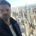 Daniel Gillies Instagram - so fun. yesterday we did a little shoot in the Empire State Building. @empirestatebldg super impressive and a such a joy when you’re promoting the best film of 2021: ‘Coming Home in the Dark’ releases this Friday on VOD and in Theatres, stateside. (Yes, I said ‘the best’… Not even fucking close. What are you gonna do about it?) 🖤 PS: Can anyone else see the little happy face in the viewfinder-binoculars chrome thing? I can’t unsee that!!!