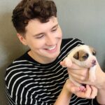 Daniel Howell Instagram - there is a two week old puppy falling asleep in my hands and i will do anything to protec him thank you @makeawishuk and @battersea for giving us and @rachael__pie this dream day Battersea Dog and Cats Home