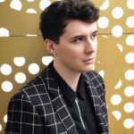 Daniel Howell Instagram - smart casual but try to make it edgy and stand in the rain in front of an office full of people watching you do a photo shoot