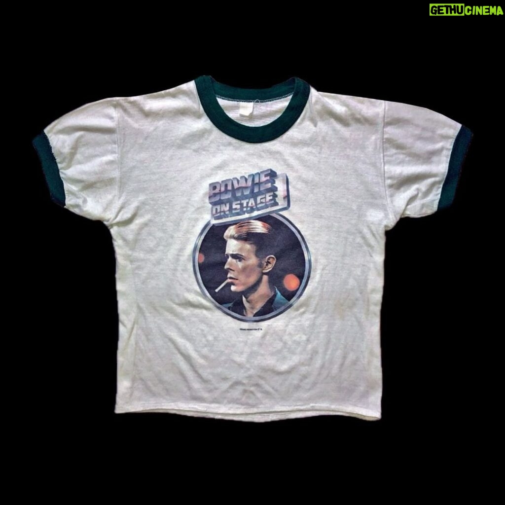 David Bowie Instagram - GOT THE RECORD AND THE T-SHIRTS? “I like the tee shirts…” Never need an excuse to post a Steve Schapiro shot of David Bowie. As you no doubt know, this particular one was taken when Bowie appeared with Cher on her CBS TV show in September 1975, the show aired in November 1975. The same image was used for the 40th anniversary Golden Years picture disc and an official 45th anniversary Young Americans T-shirt. However, a T-shirt utilising another picture of Steve‘s from the show was made available as the ON STAGE T-shirt in various colours in 1976 (see third image) and is now quite the collectors’ item. Do you still have yours? #BowieSchapiro #BowieCher #DBTshirt