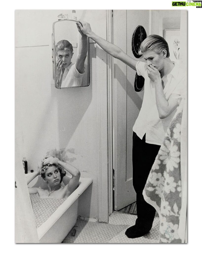 David Bowie Instagram - Please forgive the graininess of our latest Bowie Reflection. It’s an enlargement of TJ Newton (Bowie) on the set of The Man Who Fell To Earth, taken by David James. Here’s the caption from the reverse of the uncropped photo: “Mary-Lou (CANDY CLARK) tries to break down formal barriers between herself and Thomas Jerome Newton (DAVID BOWIE) when she invites him into her bathroom.” The second image is of Bowie’s original artwork (see signature bottom right), a collage he created utilising two other stills from the same scene. If you’re unfamiliar with this piece, it first appeared as a full-page in the 1976 ISOLAR tour programme and it was also an exhibit at the David Bowie Is V&A exhibition. (See last image) Look closely at Bowie’s reflection and the bubbles in the bath. A bit of pre-Photoshop scalpel work by Bowie. Thankfully, his replacement of the bubbles with Linoleum keeps us on the right side of social platform censors. The original image of Mary Lou was a little more revealing. #BowieReflections