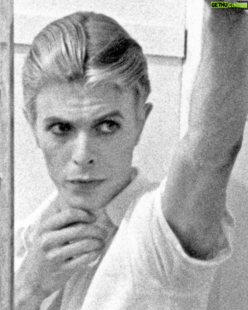 David Bowie Instagram - Please forgive the graininess of our latest Bowie Reflection. It’s an enlargement of TJ Newton (Bowie) on the set of The Man Who Fell To Earth, taken by David James. Here’s the caption from the reverse of the uncropped photo: “Mary-Lou (CANDY CLARK) tries to break down formal barriers between herself and Thomas Jerome Newton (DAVID BOWIE) when she invites him into her bathroom.” The second image is of Bowie’s original artwork (see signature bottom right), a collage he created utilising two other stills from the same scene. If you’re unfamiliar with this piece, it first appeared as a full-page in the 1976 ISOLAR tour programme and it was also an exhibit at the David Bowie Is V&A exhibition. (See last image) Look closely at Bowie’s reflection and the bubbles in the bath. A bit of pre-Photoshop scalpel work by Bowie. Thankfully, his replacement of the bubbles with Linoleum keeps us on the right side of social platform censors. The original image of Mary Lou was a little more revealing. #BowieReflections