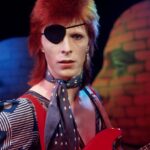 David Bowie Instagram – BOWIE COLLECTS EDISON AWARD 50 YEARS AGO TODAY

“It’s made out of old fisherman…”

On this day in 1974 (13th February), David Bowie attended a press reception at the Amstel Hotel in Amsterdam, where Ad Visser (host of Dutch music show Top Pop), presented him with the Edison Award and a certificate for the Most Popular Male Vocalist, with particular recognition given to Ziggy Stardust and The Spiders From Mars.

Recalling an earlier trip to London to visit David, Visser poured two glasses of an “old fisherman drink”, Schelvispekel*, to toast David’s win. 

David made the most of his visit to the Netherlands, including further work on the forthcoming Diamond Dogs album, several photo sessions with the new look and a recording of Rebel Rebel for Top Pop, which was broadcast a few weeks later. 

Watch a recently remastered version here on the TopPop YouTube channel: https://www.youtube.com/watch?v=d8BzPxWvdAs (Linktree in bio)

Here’s David speaking about that new ‘pirate’ look in 1993:

“I I had conjunctivitis, so I made the most of it and dressed like a pirate. Stopped just short of the parrot. I had this most incredible jacket that I was wearing that night, it was a bottle-green bolero jacket that Freddie made for me, and he got an artist to paint, using the appliqué technique, this supergirl from a Russian comic on the back. But I took the jacket off during the press conference and somebody stole it.”

The light-fingered journalist who lifted the jacket is well known and has made no attempt to hide their identity, in fact, quite the opposite. So, no need to give them more publicity here.

#BowieRebelRebel50 #BowieNetherlands #BowieTopPop

(Continued in comments)