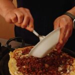 David Chang Instagram - Still not pro homemade pizza …but I made this thing with leftover @momofukugoods chili crunch pork ragu and pizza dough I found in the fridge. Good things happen when you cook without a safety net. Watch the full video at the link in my bio.