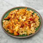 David Chang Instagram - Fried rice is the best breakfast…probably make this for breakfast more than anything else. Whatever is leftover in the fridge goes in - also used @momofukugoods soy, savory, and chili crunch. Watch the full video at the link in my bio.