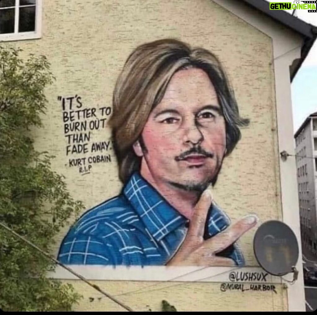 David Spade Instagram - I think this is going around again. The picture of me on a building in Austria by an artist. He says its kurt Cobain the quote is wrong also. Its from neil young ( i think). It’s kind of funny and meant to be confusing. #tadah.
