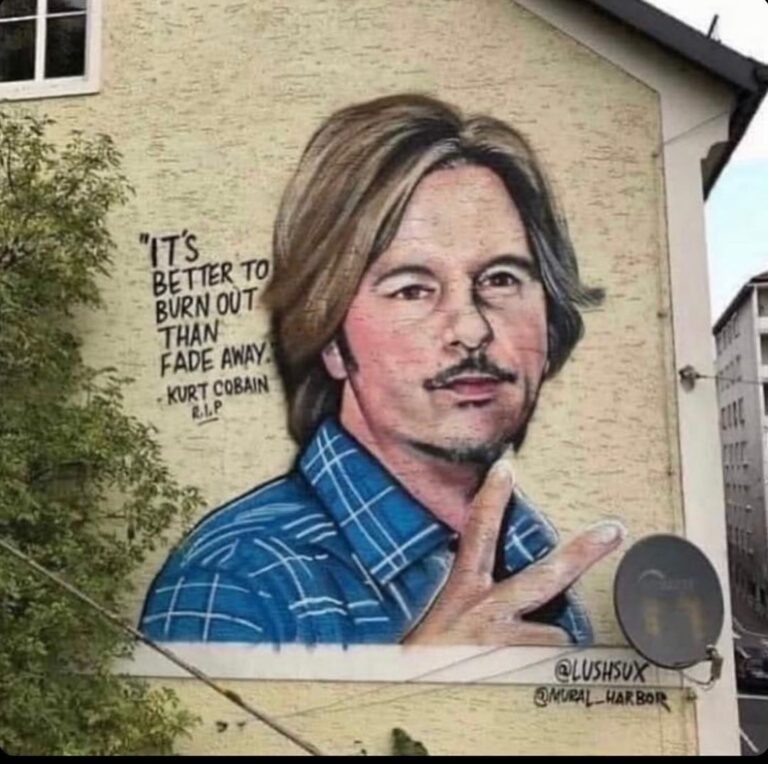 David Spade Instagram - I think this is going around again. The picture of me on a building in Austria by an artist. He says its kurt Cobain the quote is wrong also. Its from neil young ( i think). It’s kind of funny and meant to be confusing. #tadah.
