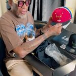 Dennis Rodman Instagram - Here’s my Lids HD Exclusive Dennis Rodman Collection with the NBA and Mitchell & Ness.  Check out each hat designed by a different hairstyle from my NBA days.  Get yours starting on December 22nd on LidsHD.com and in select stores. @lidshatdrop @lids