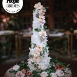 Derek Hough Instagram - "Regal redwoods" was the theme of @derekhough and @hayley.erbert's wedding in Carmel, California. From Hayley's custom Marchesa wedding gown and @inesdisanto reception dress to the opulent chandeliers and florals, see all the photos from their star-studded celebration at the link in bio. 📷: @amyandstuart 📋: @simplytroy 💐: Jimmy Hartman of @inblumela 👗: @marchesafashion and @inesdisanto 💇‍♀️: @jill901 💄: @emmawillishmu 🪧: @katecozziegraphicarts 🎥: @whiteinrevery 📍: @santaluciapreserve 🍰: @kellygraycakes 💡: @signaturechandeliers 🍽️: @theonicollection