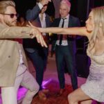 Derek Hough Instagram - Love ❤️ these two humans and so happy to celebrate with them on their big day! What makes these photos even better is looking at the reactions of people in the background 😂… ooo a flower 🌸 📷: @christinamcneill