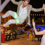 Derek Hough Instagram - Love ❤️ these two humans and so happy to celebrate with them on their big day! What makes these photos even better is looking at the reactions of people in the background 😂… ooo a flower 🌸 📷: @christinamcneill