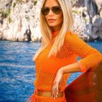 Dorit Kemsley Instagram - Our neon mesh top is great for day to night 🧡 Pair with your favorite bikini, boyfriend jeans, or over a tank for a chic look. Only a few sizes left and 75% off @beverlybeach ..