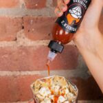 Dustin Poirier Instagram - Elevate your snack game by spicing up some popcorn with a dose of Poirier’s Louisiana Style Hot Sauce 🔥🍿🔥