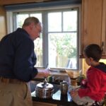 Elizabeth Warren Instagram - Bruce watches our grandson Atticus as he wrestles with the getting the bag open. He gently reminds the boy to get a level—not a heaping—spoonful of beans. He smiles when AMann dumps the beans into the grinder without spilling a single one. Every step along the way Bruce is patient. Making coffee The Bruce Mann Way takes time, and over the past several years, he and our grandson have evolved their routine. Morning coffee has been a part of their time together since the days when Bruce lifted toddler Atticus onto the kitchen counter and the child’s sole job was to push the button to start grinding the beans. Through the years, Atticus has taken on more of the work; now he’s just short of pouring the boiling water. I hope that when Atticus is grown, he will remember morning coffee. I also hope he will have learned something about the patient care that reflects deep love. Patience does not come naturally to Bruce. He is a Boston driver—no patience there. He switches off mediocre movies. He starts class precisely on time—late-comers beware. But he is patient where it counts. Patient with grandchildren. Patient with dogs. Patient with me. Today is Bruce’s birthday—and I have the chance to say very impatiently that I love him. Happy birthday, Sweetie.