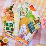Ellen DeGeneres Instagram - We LOVE Summer! ☀️ How ‘bout you?! This season, we hope the BE KIND. box will inspire you to have the perfect summer day with the people you love. Check out these 10 products - yes, TEN! - by 6 amazing brands, and see for yourself! Did someone say picnic?! 🧺 Enjoy iced @vahdamindia tea this Summer with friends. Plus, Vahdam is certified Climate & Plastic Neutral, and 1% of revenue goes toward the education of their farmers’ children. 🍃 They’re green, reusable, and oh-so-cute! Get your hands on @fullcircle Tough Sheet Reusable Plant Towels and Ziptuck Lunch Bag Set. Trust us when we say they will be snacktime’s best friend! 📕 You’ll LOVE "Slightly South of Simple" By Kristy Woodson Harvey, our pick for a fun Summer read! 📚 @booksiobooks is a woman-owned, charity-driven online bookstore that donates 10% of all profits each month to charity. We ♥️ this Heart Cheese Board & Cheese Knives Set from @theellenshop, and we know you will too! Gather your friends, loved ones, or let’s be real — yourself, and enjoy! 😻You are going to love @100percentpure Coffee Bean Caffeine Eye Cream! It is totally vegan with rejuvenating & restorative ingredients. Also, the company’s core mission is rooted in improving the lives of humans and animals across the globe. 👄 Craving some Summer self care? We’re loving @mineralfusion Hydro Shine Lip Glosses in TWO shades! They’re hypoallergenic, vegan, cruelty-free, gluten-free, and contain no harsh ingredients, artificial fragrances, or parabens. ✍️In an increasingly digital world the written word can mean so much. That’s why we included this set of postcards📮designed by our very own box artist @sabinafenn ! These beautiful cards can also be used as wall art with a simple frame!