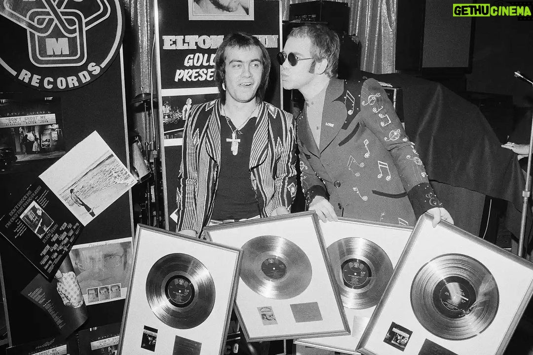 Elton John Instagram - ”Don't Shoot Me I'm Only The Piano Player” was our first No.1 record in the UK, and second in the US. Here is a photo of @bernietaupinofficial and me with some of our first gold records in 1973 (little did we know how great our collection would become). 📸@michaelputlandphotography