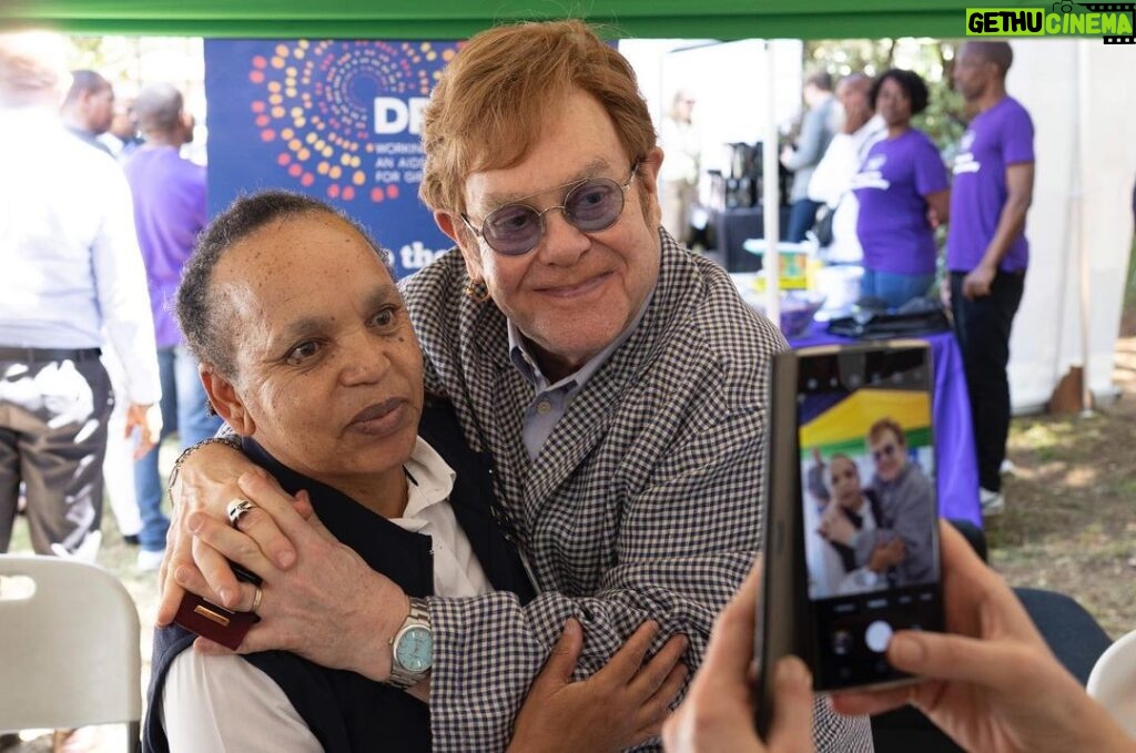 Elton John Instagram - What a week it’s been visiting @ejaf and @pepfar HIV prevention and care projects in Johannesburg with Congress leaders to celebrate what the past 20 years of funding has achieved – saving lives and creating brighter futures for millions of people. @davidfurnish and I were thrilled to meet so many young people taking part in @ejaf programmes. Through innovative tech we are helping young people talk about sex, love and relationships and supporting their mental and sexual health. The future is theirs for the taking! We must keep our foot on the accelerator to continue this remarkable progress in partnership with @pepfar. My thanks go to all of the amazing medical staff, youth mentors, educators and of course those wonderful young people we met along the way. Til next time South Africa! #HIV #AIDS #PEPFAR20 #Triggerise #BWiseHealth #Praekelt