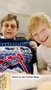 Elton John Instagram - Went with @eltonjohn to watch our boyhood teams play each other, to celebrate 2 years of Merry Christmas. Out now on all platforms, and Merry Christmas you wonderful people x