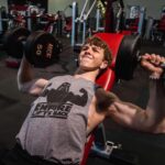 Ethan Wacker Instagram - A lot of people have been asking me for my workout routine. This is my chest workout. KEEP IN MIND I AM NOT A TRAINED PROFESSIONAL!! I am just someone who works out a lot and this is what works for me: •Start with 5-10 mins of stretching •Flat Bench Press: 5 sets 8-10 reps per set. 2 sets of pause reps at the end with reduced weight, 8-10 reps per set. •Incline Dumbbell Bench Press: 5 sets, 10-12 reps per set •Chest Flys: 5 sets, 10-12 reps per set •Chest Press Machine: 3 sets, 10-15 reps per set •Dips: 3 sets, to failure each set •Cable Flys: 3 sets, 8-10 reps per set. Lmk in the comments if you want to see the workouts I do for back and biceps, shoulders, and abs. I’ll get back to doing legs soon, still got about a month or so until I can start using my leg in workouts. UFC GYM
