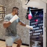 Francis Ngannou Instagram - Think you can hit like me? @Gymshark are giving £10,000 to anyone who can hit as hard as me. Got what it takes? Tag a friend in the comments, sign up (link in bio) and head to Kachette, London to throw a punch/kick/crow bar at the bag on March 2nd. Good luck. I’ll be watching! #ad