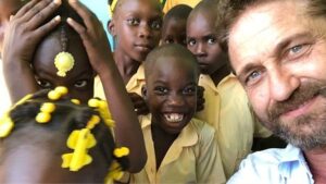Gerard Butler Instagram - What an eventful couple of weeks. Been cheered up to no end by these beautiful souls who despite living in a country that has gone through so much hardship, have nothing but love to give. A real lesson for me right now. So pleased to be in Haiti with @MarysMeals visiting schools to see the wonderful work they do. Communities are transformed by what @MarysMeals does to feed children in a place of education. It’s such a simple idea that works really well. I’ve seen it in action in Liberia, and now Haiti.  Link in bio for their website MarysMeals.org, or follow @MarysMeals for more pictures and videos from this trip! #Haiti #MarysMeals #school #meals #hope #joy #food #education