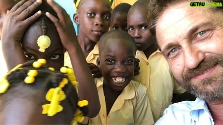 Gerard Butler Instagram - What an eventful couple of weeks. Been cheered up to no end by these beautiful souls who despite living in a country that has gone through so much hardship, have nothing but love to give. A real lesson for me right now. So pleased to be in Haiti with @MarysMeals visiting schools to see the wonderful work they do. Communities are transformed by what @MarysMeals does to feed children in a place of education. It’s such a simple idea that works really well. I’ve seen it in action in Liberia, and now Haiti.  Link in bio for their website MarysMeals.org, or follow @MarysMeals for more pictures and videos from this trip! #Haiti #MarysMeals #school #meals #hope #joy #food #education