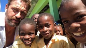 Gerard Butler Instagram - What an eventful couple of weeks. Been cheered up to no end by these beautiful souls who despite living in a country that has gone through so much hardship, have nothing but love to give. A real lesson for me right now. So pleased to be in Haiti with @MarysMeals visiting schools to see the wonderful work they do. Communities are transformed by what @MarysMeals does to feed children in a place of education. It’s such a simple idea that works really well. I’ve seen it in action in Liberia, and now Haiti.  Link in bio for their website MarysMeals.org, or follow @MarysMeals for more pictures and videos from this trip! #Haiti #MarysMeals #school #meals #hope #joy #food #education