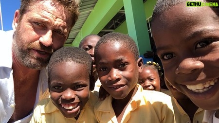 Gerard Butler Instagram - What an eventful couple of weeks. Been cheered up to no end by these beautiful souls who despite living in a country that has gone through so much hardship, have nothing but love to give. A real lesson for me right now. So pleased to be in Haiti with @MarysMeals visiting schools to see the wonderful work they do. Communities are transformed by what @MarysMeals does to feed children in a place of education. It’s such a simple idea that works really well. I’ve seen it in action in Liberia, and now Haiti.  Link in bio for their website MarysMeals.org, or follow @MarysMeals for more pictures and videos from this trip! #Haiti #MarysMeals #school #meals #hope #joy #food #education